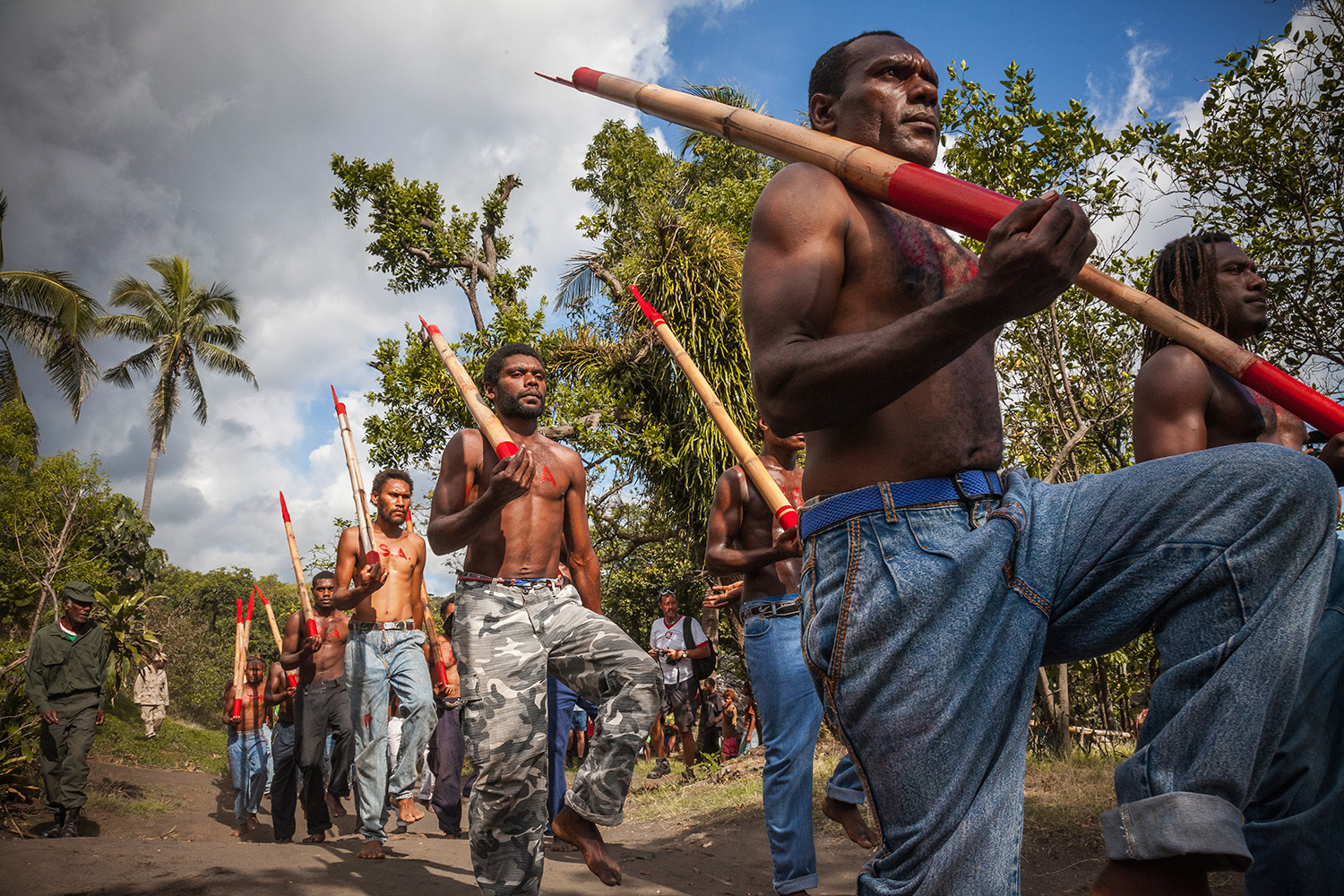 Cargo cult members march with bamboo "rifles" during the celebration of John Frum's Day in Lamakara village.